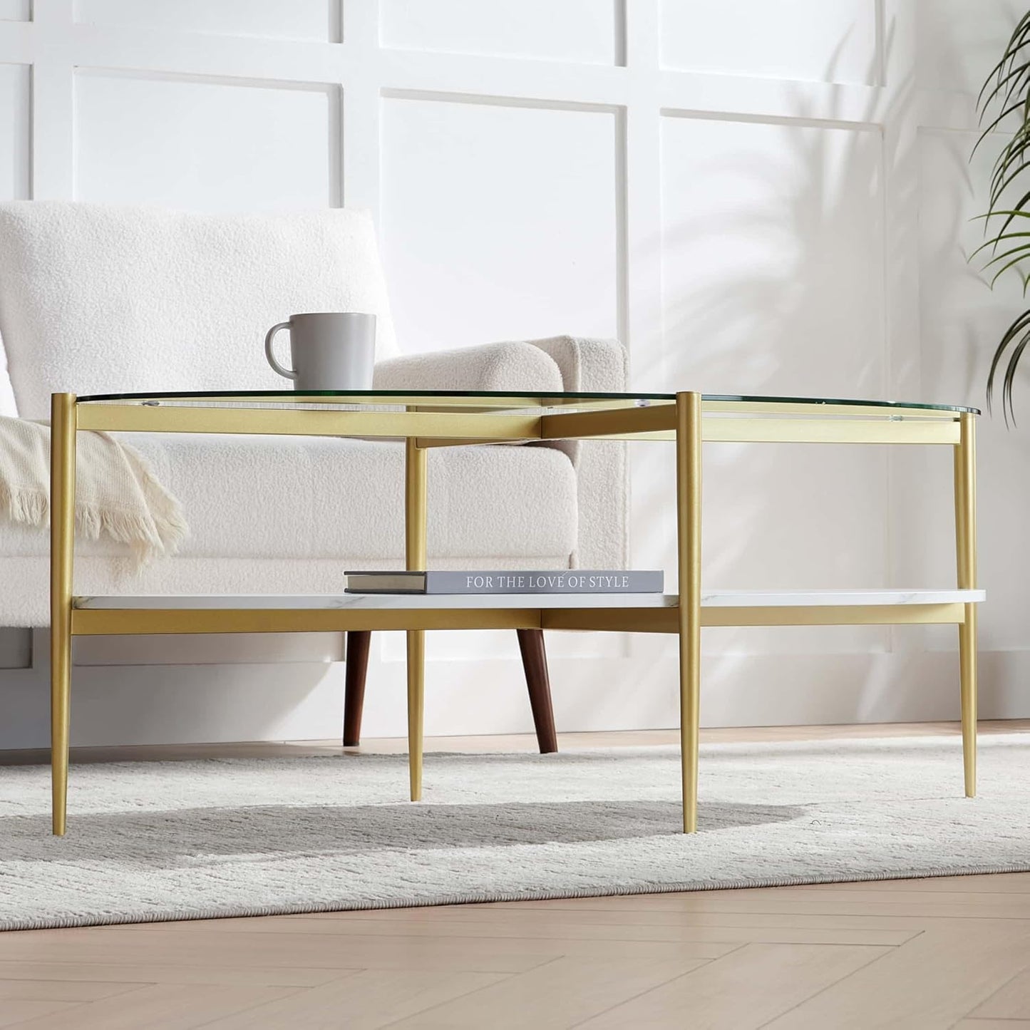 Oval Glass Coffee Table, Mid-Century Modern Design, L43 x W22 x H17 inch, Surfboard Shaped Clear Glass Top and White Marble Finish Wood Shelf, Tapered Legs with Gold Finish Frame